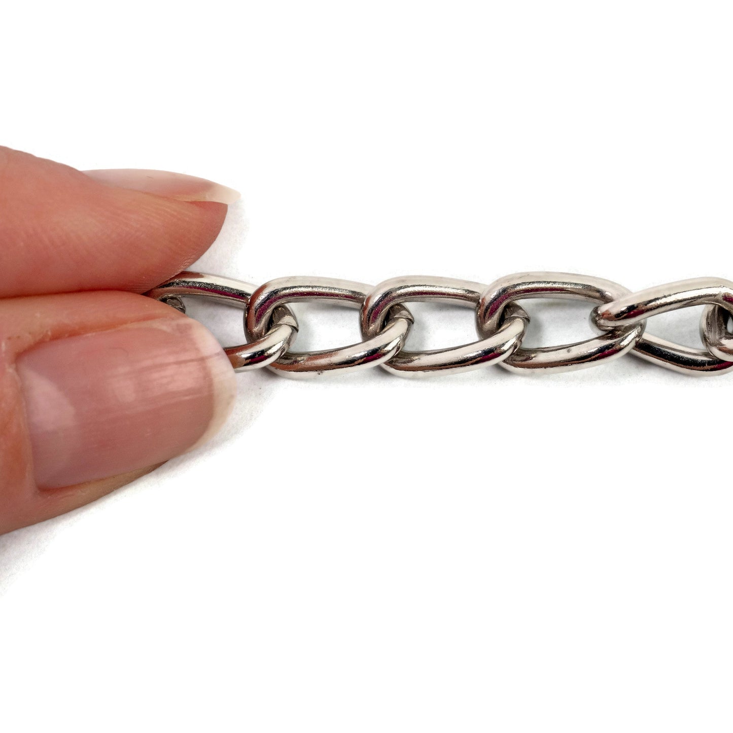 Hand holding a silver chain on a white background