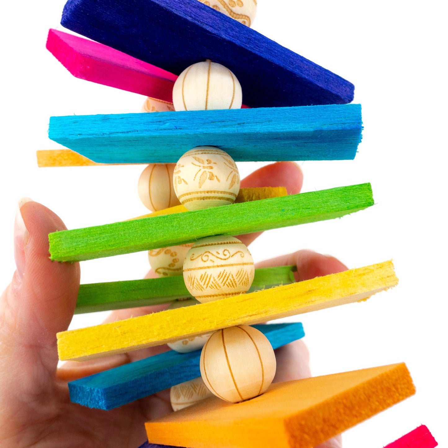 A close up photo reveals abstract line drawings on each bead.