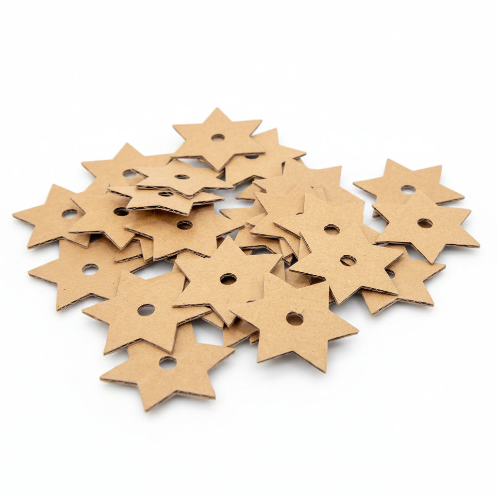 A pile of small star-shaped cardboard embellishments with pre-drilled holes, shown on a clean white background.