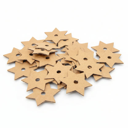 A pile of small star-shaped cardboard embellishments with pre-drilled holes, shown on a clean white background.
