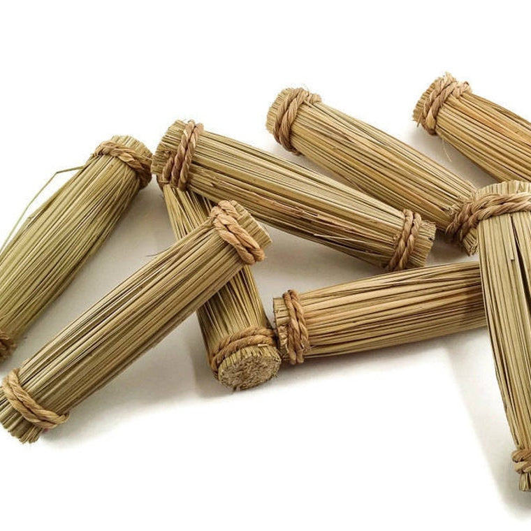 Bundles of dried grass tied together with seagrass cord.