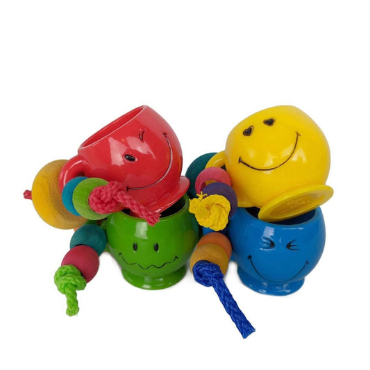 A set of colorful bird toys each featuring a unique smiley face.