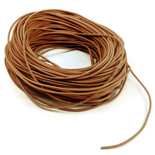 Coiled brown leather cord on a white background