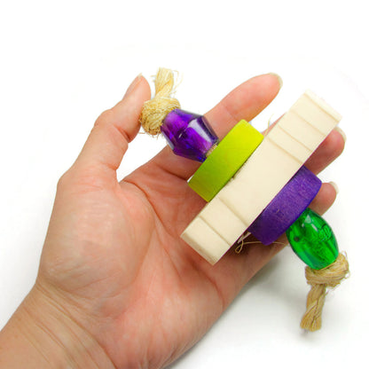 Sparkle foot toy for parrots shown held in a hand for scale.