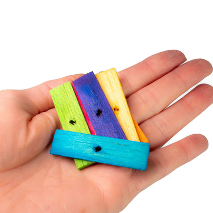 Colorful wooden blocks held in a hand against a white background