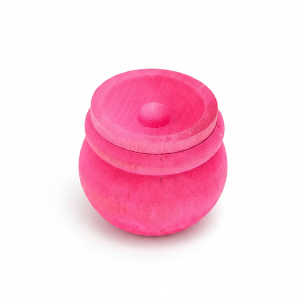 A small round, vibrant pink wooden box with a lid.