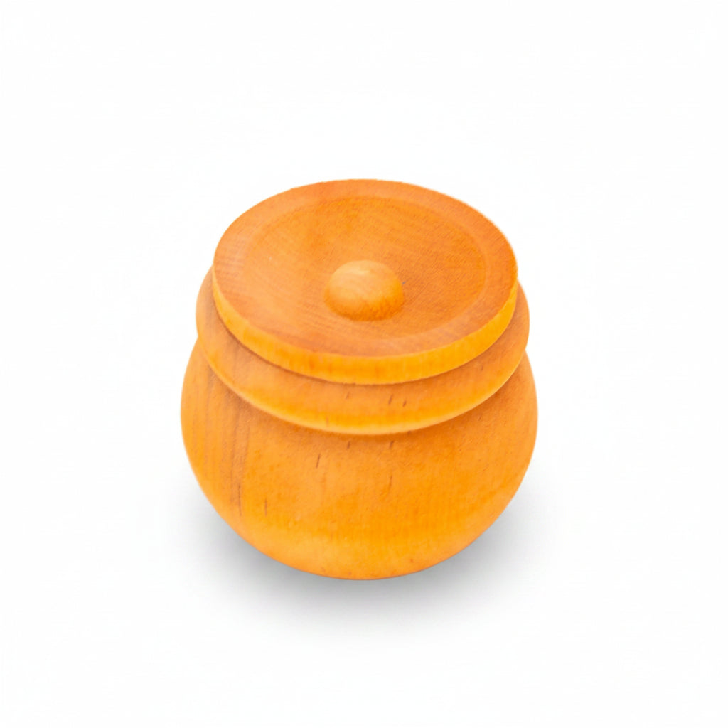 A small round wooden lidded container or box in a warm orange color, photographed on a clean white background.