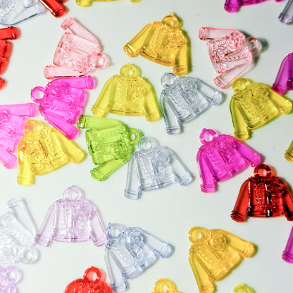 Small translucent plastic jacket-shaped charms or pendants in multiple colors, including pink, yellow, clear, green, purple, and red, scattered on a white background.