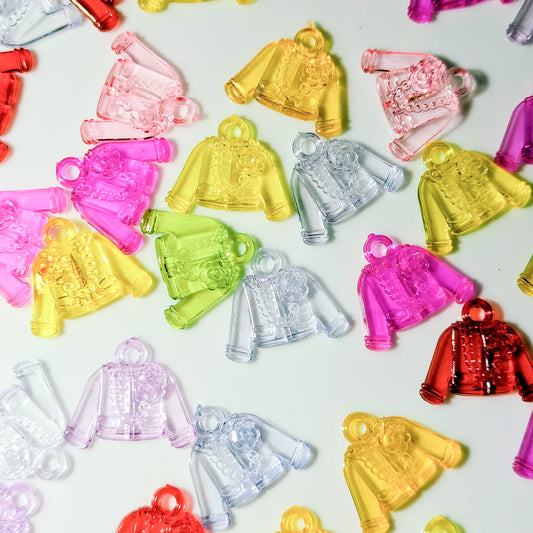 Small translucent plastic jacket-shaped charms or pendants in multiple colors, including pink, yellow, clear, green, purple, and red, scattered on a white background.